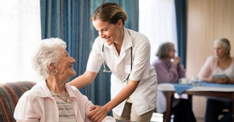 caretaker assisting elderly patient